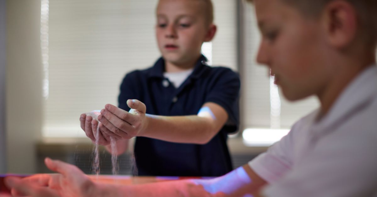 students participating in multisensory learning with ar sandbox